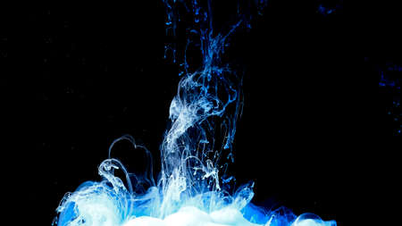 Blue and white cloud of ink on a black background. Drops of blue ink in water. Cosmic star background. Awesome abstract background. Beautiful wallpaper for your desktop.の写真素材
