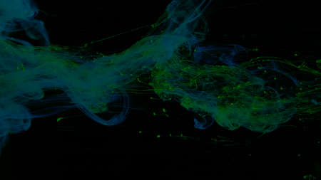 Blue-green cloud of ink on a black background. Beautiful abstract background. Blue-green watercolor...