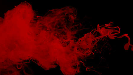 Red cloud of ink. Awesome abstract background. Drops of red ink in water. Cosmic star background. Red watercolor paints in water on a black background. Beautiful wallpaper for your desktop.の写真素材