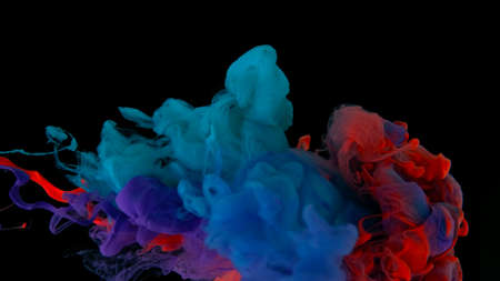 Colored cloud of ink on a black background. Drops of blue, purple and pink ink in water. Blue, purple and scarlet watercolor paints in water on a black background. Awesome abstract background. Beautiful wallpaper for your desktop.の写真素材