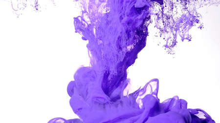 Purple watercolor ink in water on a white background. Fascinating abstract background. Purple paints are mixed in water. Colored cloud of ink on a white background.の写真素材