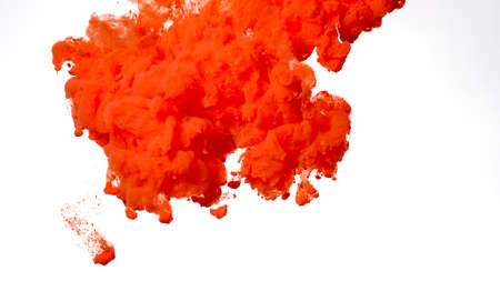 Red-orange acrylic paints are mixed in water. Colored cloud of ink on a white background. Red-orange watercolor ink in water on a white background. Beautiful abstract background.の写真素材
