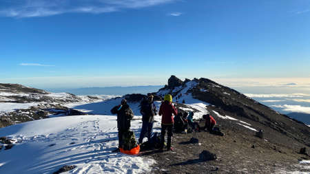 Kilimanjaro, Tanzania - January 1, 2022: Tourists rest and drink hot tea. Morning in the mountains. Climbing Kilimanjaro.のeditorial素材