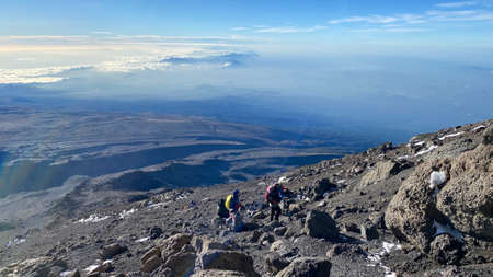 A group of tourists climb up the mountain. Climbing Kilimanjaro, Tanzania, Africa. beautiful mountain scenery.のeditorial素材
