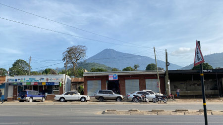 Arusha, Tanzania - January 7, 2022: Walking along one of the streets of the city of Arusha. Mount Kilimanjaro is visible in the background.のeditorial素材