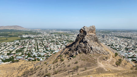 View of the city from a bird's eye view. Beautiful powerful mountains. Sulaiman-Too is a rocky sacred mountain and a symbol of the city of Osh. The amazing nature of Kyrgyzstan.の写真素材