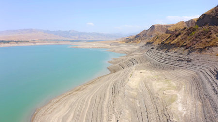 A peaceful view of a beautiful mountain lake. Rocky mountains, hills and slopes of Kyrgyzstan. natural background.の写真素材