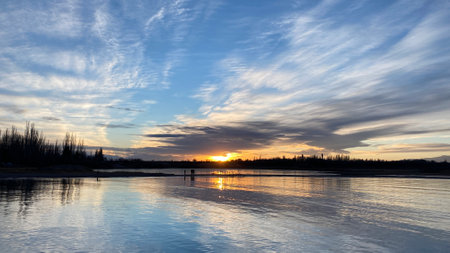 Beautiful sunset over an amazing mountain lake. The pearl of Kyrgyzstan - Lake Issyk-Kul at sunset. Calm calming natural background. summer landscape.の写真素材