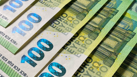 money background. Close-up of part of one hundred euro bills. Single currency of the European Union. European currency. 100 euros. cash banknotes. Financial business background concept. background of cash euro bills.の写真素材