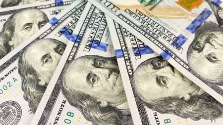 One hundred US dollars. The American national currency. The $100 bills are fanned out. cash...