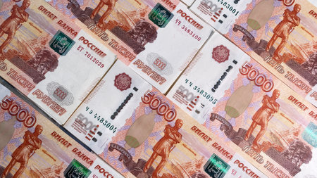 Several stacks of five thousand ruble bills are lying on the table. Tickets of the Bank of Russia....