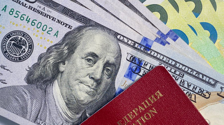 Banknotes of $100 and 100 euros are invested in a foreign passport of the Russian Federation. close-up. Cash bills of one hundred US dollars. American and European national currencies. Financial business background concept.の写真素材