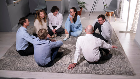 A seminar from a mentor. The company's staff is on a retreat in a country house. A group of young...