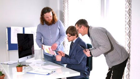 The company's lawyer advises his boss while he reviews important documents with schedules. A typical...