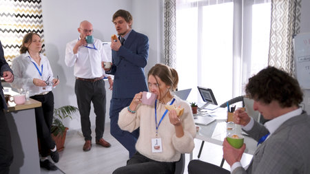 A break at work. The staff of the business company is having lunch in the office. A group of...