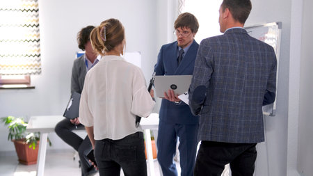 Morning planning session. The director of the company discusses working issues with his subordinates...