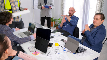 Two businessmen of the customer require a time-out at a meeting to coordinate the construction of an...