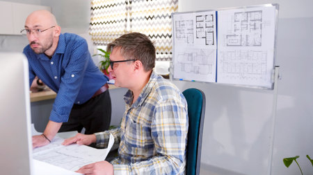 Two men work in a construction office. Two architects are discussing a country house project. The...