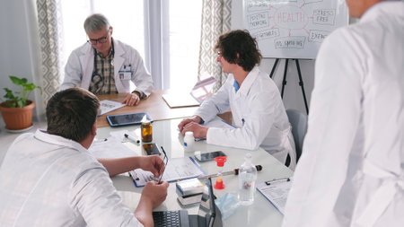 Several doctors are sitting at a table and discussing the case with a patient. The scene is serious...