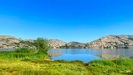 Rest at Lake Shalkar in western Kazakhstan. A beautiful lake belonging to the group of Five Kokshetau lakes. The reservoir is surrounded by rocky mountains. Tourismの写真素材