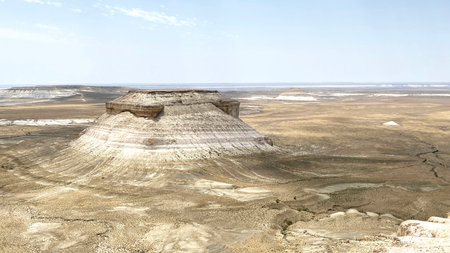 View of the former bottom of the ancient Tethys Ocean in the desert area of Kazakhstan. Landmark of Mangystau is The Bozzhyra Tract. Desert landscape with a large rock in the middleの写真素材