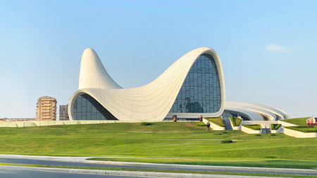 Heydar Aliyev Center. Masterpiece of modern architecture in the style of postmodernism, built by Zaha Hadid. Landmark of Azerbaijan. Large building with a graceful curved roofの写真素材