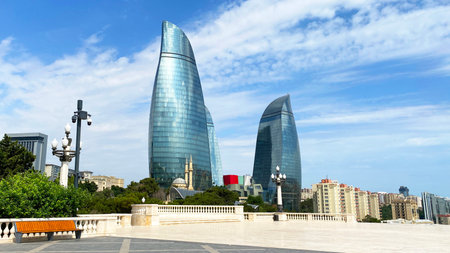 View of the Flame Towers in Baku. Sights of Azerbaijan. Tourism and adventure. Cutting-edge space architecture. The sky is blue, with a few clouds on itの写真素材