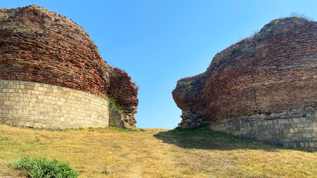 View of two round brick towers - parts of the fortress wall, which was once the southern entrance to the city of Gabala, Azerbaijan. Ruins of the ancient city of Chukhur Gabalaの写真素材
