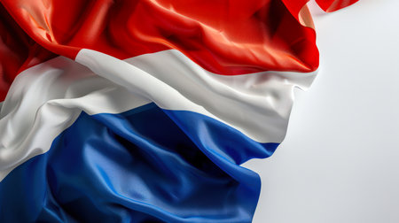 A striped flag of blue, white and red colors flutters in the wind on a white background. Flag background for the design. The flag of the Netherlands. Citizenship and immigration. Tourism and prideの素材