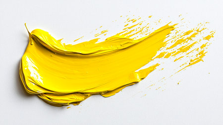 Close-up of a laconic smear of yellow paint on a white background. Hand-drawn. A textured dense brush stroke. An element for the design. The strokes are almost like a wave, and it seems that they are moving on a white backgroundの素材