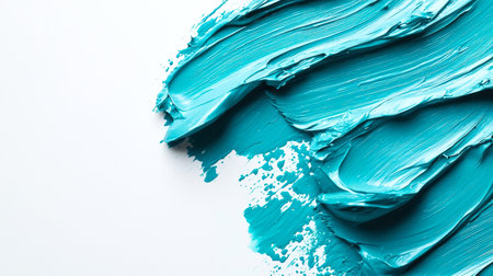 Strokes of turquoise thick paint on a white background, top view, close-up. Abstract artistic marine background for design. A blue brush stroke, hand-drawn. The strokes are dense and textured. The blue color is bright and boldの素材