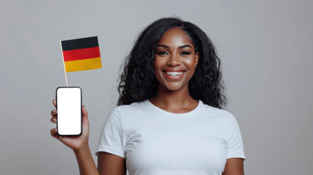The concept of a German-style party invitation. A traditional holiday in Germany. A mockup of a phone in the hand of a pretty black woman. Education and tourism in Germany. The concept of patriotism and prideの素材