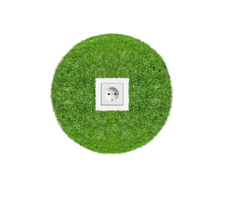 Energy concept outlet in fresh spring green grass, Abstract energy background with outlet in grassの写真素材