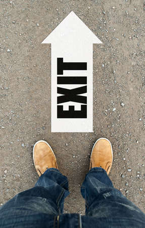 Welcome sign on road. man on a tarmac road with the word welcome. the road arrowの写真素材