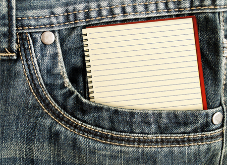 A little note in the side pocket of jeans. White notebook in jeans pocketの写真素材