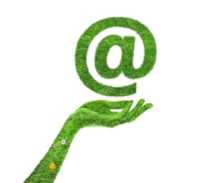 Green grass Email Symbol in hand. Visualization of an address symbol in grassの写真素材