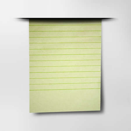 Vertical hanging a sheet of paper in-line. Hanging green paper sheet from notebook