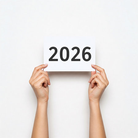 Hands holding a card with the year 2026, isolated on a white background.の写真素材
