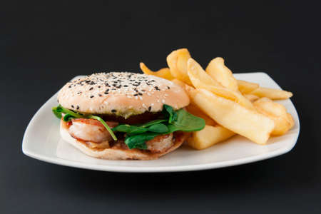 Burger with shrimp and potato friesの写真素材