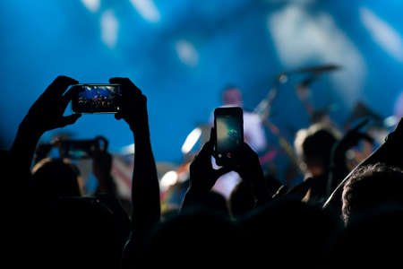 Concert crowd takes on a mobile phoneの写真素材