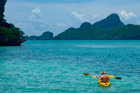 Canoeing in the blue oceanの写真素材
