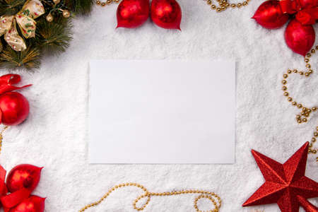 Sheet of white paper on snow christmas background top view mock upの写真素材
