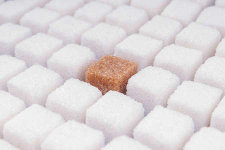 Many cubes of white sugar with one other. Concept not like everyone