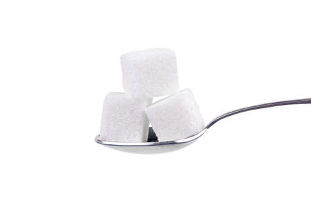 Spoon with white sugar on a white backgroundの写真素材