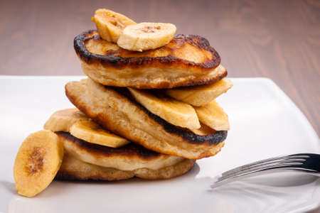 Pancakes with banana on a wooden backgroundの写真素材