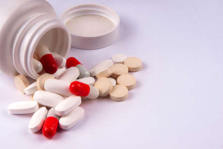 Pack of scattered tablets on a light backgroundの写真素材