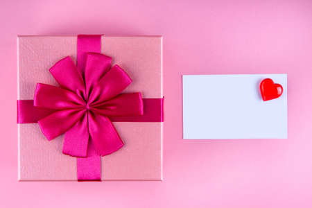 Present with Love note with red heart on pink background mock up, copyspaceの写真素材