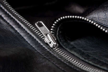Iron zipper on a black leather jacket, needlework concept.の写真素材