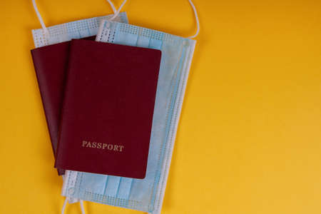 Passports with masks on  yellowの写真素材