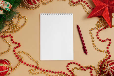 Flatlay a notebook with a pen lies on the Christmas table. Christmas concept. Mock up.の写真素材